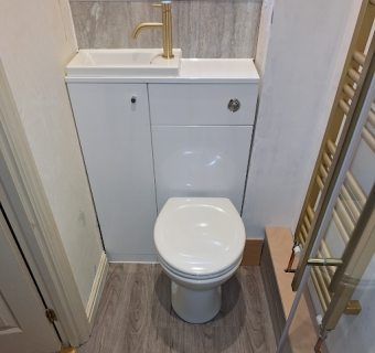 This combined wash basin and toilet unit was installed for a...